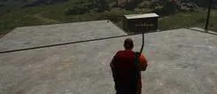 Xernel in SCUM while aiming a bow on a concrete roof: loot labels with names and distance around a shed and a target box
