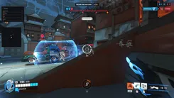 UDP in Overwatch on an escort map: enemy skeletons behind a barrier, the aim circle on a target, the ultimates panel and radar on the left