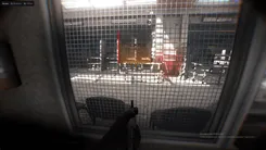 Arcane drone ESP in Bodycam behind a mesh fence: an orange filled box on a Kamikaze drone with its owner name in brackets and 4 m distance